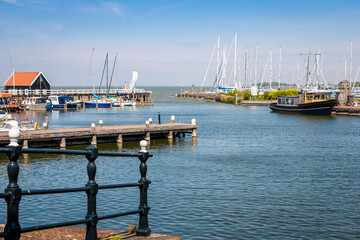 Fototapeta premium Hindeloopen a beautiful town in the Netherlands on the IJsselmeer, province of Friesland with canal boats and a harbor