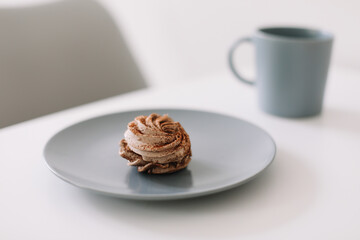 Cup of coffee with marshmallows and flowers on the table. Romantic morning. Tasty breakfast. Flat lay, top view, copy space.