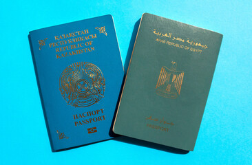 Kazakhstan and Egypt passports on blue background. Two international passports of different counties