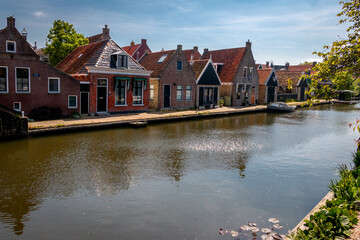 Fototapeta na wymiar Hindeloopen a beautiful town in the Netherlands on the IJsselmeer, province of Friesland with canal boats and a harbor