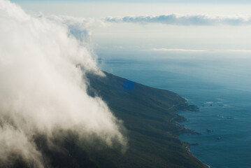 Tablecloth over Table Mountain in Cape Town, South Africa. View above the clouds on Table Mountain and blue atlantic ocean. Top view.