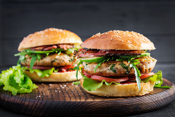 Big sandwich - hamburger burger with turkey meat,  tomato,  bacon and lettuce.