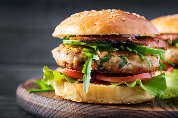 Big sandwich - hamburger burger with turkey meat,  tomato,  bacon and lettuce.