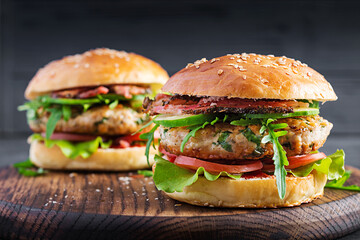 Big sandwich - hamburger burger with turkey meat,  tomato,  bacon and lettuce.