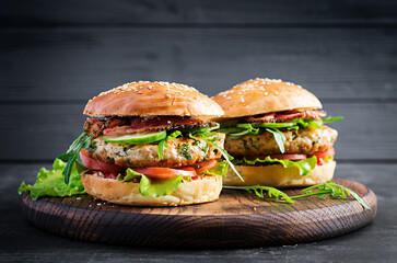 Big sandwich - hamburger burger with turkey meat,  tomato,  bacon and lettuce.