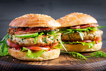 Big sandwich - hamburger burger with turkey meat,  tomato,  bacon and lettuce.