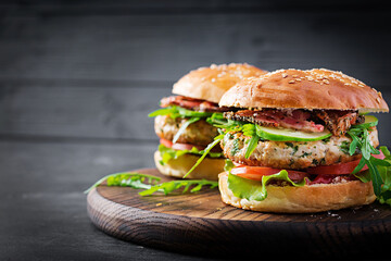 Big sandwich - hamburger burger with turkey meat,  tomato,  bacon and lettuce.