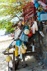 Plastic buoys and nets on a wooden staircase by the beach