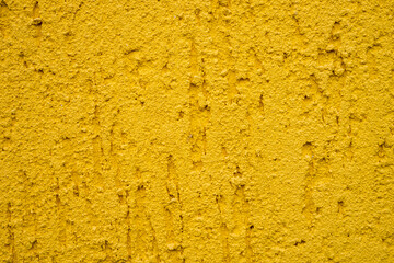Background of yellow stone wall with drips