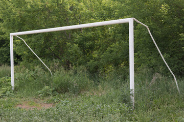 Old soccer football gate on field with green grass