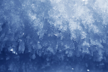 close up macro of ice surface inside fridge wall for texture background