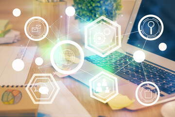 Computer on desktop with social network theme icon. Multi exposure. Concept of international connections.