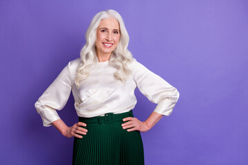 Portrait of candid lovely old woman put hands waist look good enjoy her clothes isolated over vibrant color background