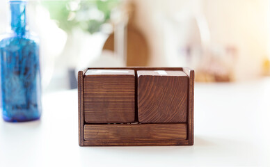 A wooden eternal calendar in a light interior. square cubes. Free space for the logo, any inscription and date