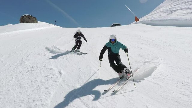 Two male ski athlethes show there awesome skills on ski's. Perfect syncron slaom skiing in beatiful composition on a steep ski slope in tyrol.  Slomotion sixty p. steady filming.