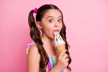 Closeup photo of beautiful little lady two cute long tails hold big cone ice cream can't wait lick tongue try vanilla taste wear summer dress isolated pastel pink color background - obrazy, fototapety, plakaty