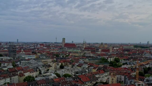 Stabilzed drone shot of Munichs skyline and swing down to the flowing Isar river.