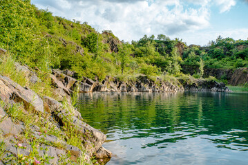 Obraz premium Stone quarry with lake. Stone mining in the canyon. deep water