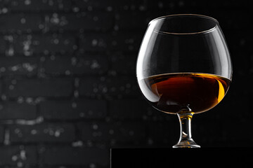 Whisky glass against dark black grunge wall