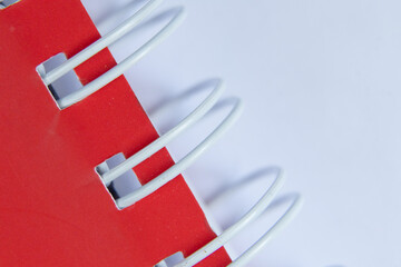 red spiral notebook close-up on a white background