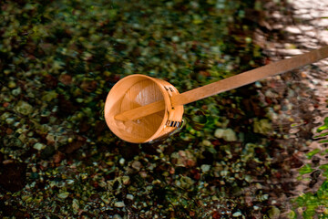 柄杓で水を掬う