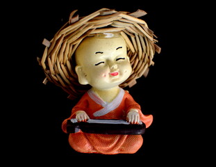Savar-Dhaka, Bangladesh-June 11, 2020: Vintage porcelain Buddhist dolls figurine cutout, isolated...