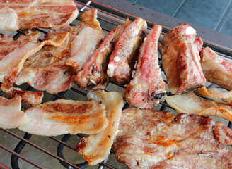 mixed grill with pork ribs and bacon on the grill