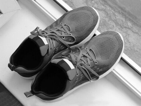 Top view of men's running shoes, black and white
