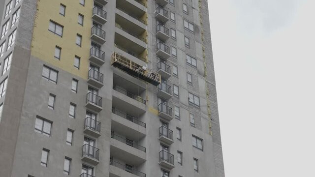 People descend in the construction cradle