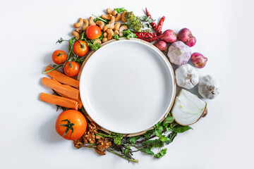 Healthy Eating. White ceramic dish surrounding with fresh organic food ingredient, vegetables, herb and spices, on white background - 357160228