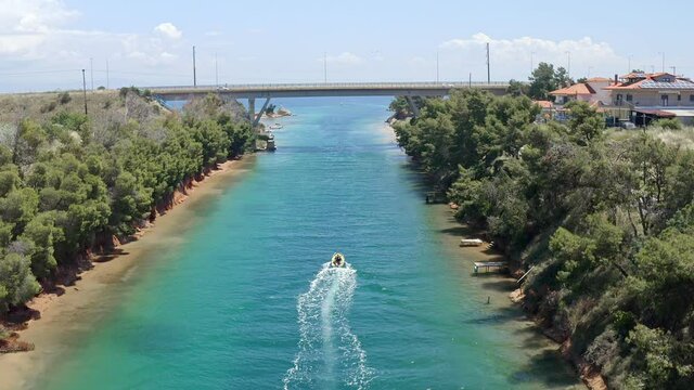 Drone footage of small motor boat crossing Nea Potidea canal, which connects Toroneos Bay with the Gulf of Thermaikos. Greece, Kassandra, Halkidiki