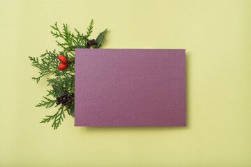 Purple blank paper. Holiday greeting. Juniper festive decor. Olive background.