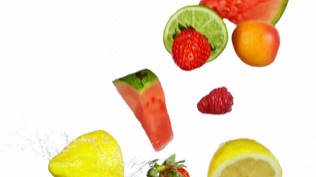 Fresh Fruit Slices Falling with Water Splash in Super Slow Motion. Shot at 1000 fps