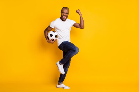 Full Length Body Size View Of His He Nice Attractive Lucky Cheerful Cherry Guy Holding In Hand Ball Soccer Having Fun Isolated Over Bright Vivid Shine Vibrant Yellow Color Background