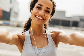 Happy fitness woman taking selfie