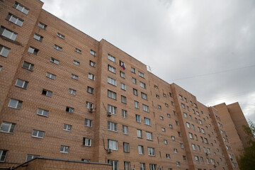 Russian flag in the window of a residential building