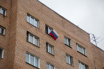 Russian flag in the window of a residential building