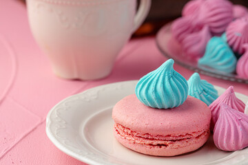 Cup of coffee with colorful cookies close up