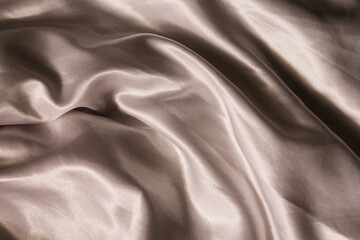 Luxurious silk fabric. Crushed silk. Soft waves of silk bed linen. Atlas.