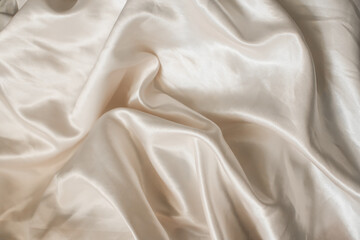 Luxurious silk fabric. Crushed silk. Soft waves of silk bed linen. Atlas.