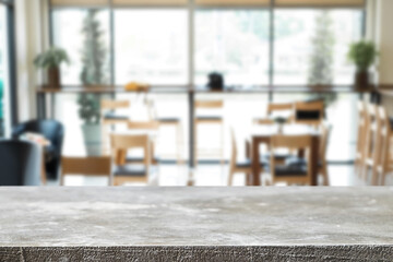 Empty wooden desk space platform over blurred restaurant or coffee shop background for product display montage.