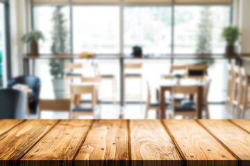 Empty wooden desk space platform over blurred restaurant or coffee shop background for product display montage.
