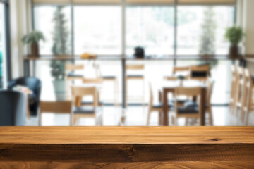 Empty wooden table space platform and blurred restaurant or coffee shop background for product display montage.