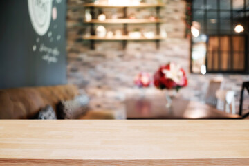 Empty wooden table space platform and blurred restaurant or coffee shop background for product display montage.