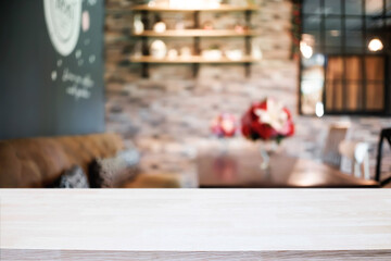 Empty wooden table space platform and blurred restaurant or coffee shop background for product display montage.