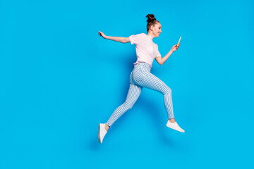 Fototapeta na wymiar Full length body size view of her she nice attractive cheerful cheery girl blogger jumping going using cell app 5g blogging influencer isolated on bright vivid shine vibrant blue color background