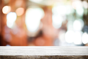 Empty wooden table space platform and blurred resturant or coffee shop background for product display montage.
