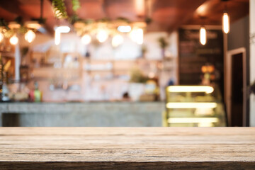 Empty wooden desk space platform and blurred resturant or coffee shop background for product display montage.