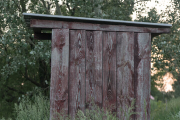 Wooden toilet in a Russian village in the summer