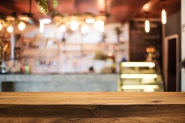 Empty wooden desk space platform and blurred resturant or coffee shop background for product display montage.